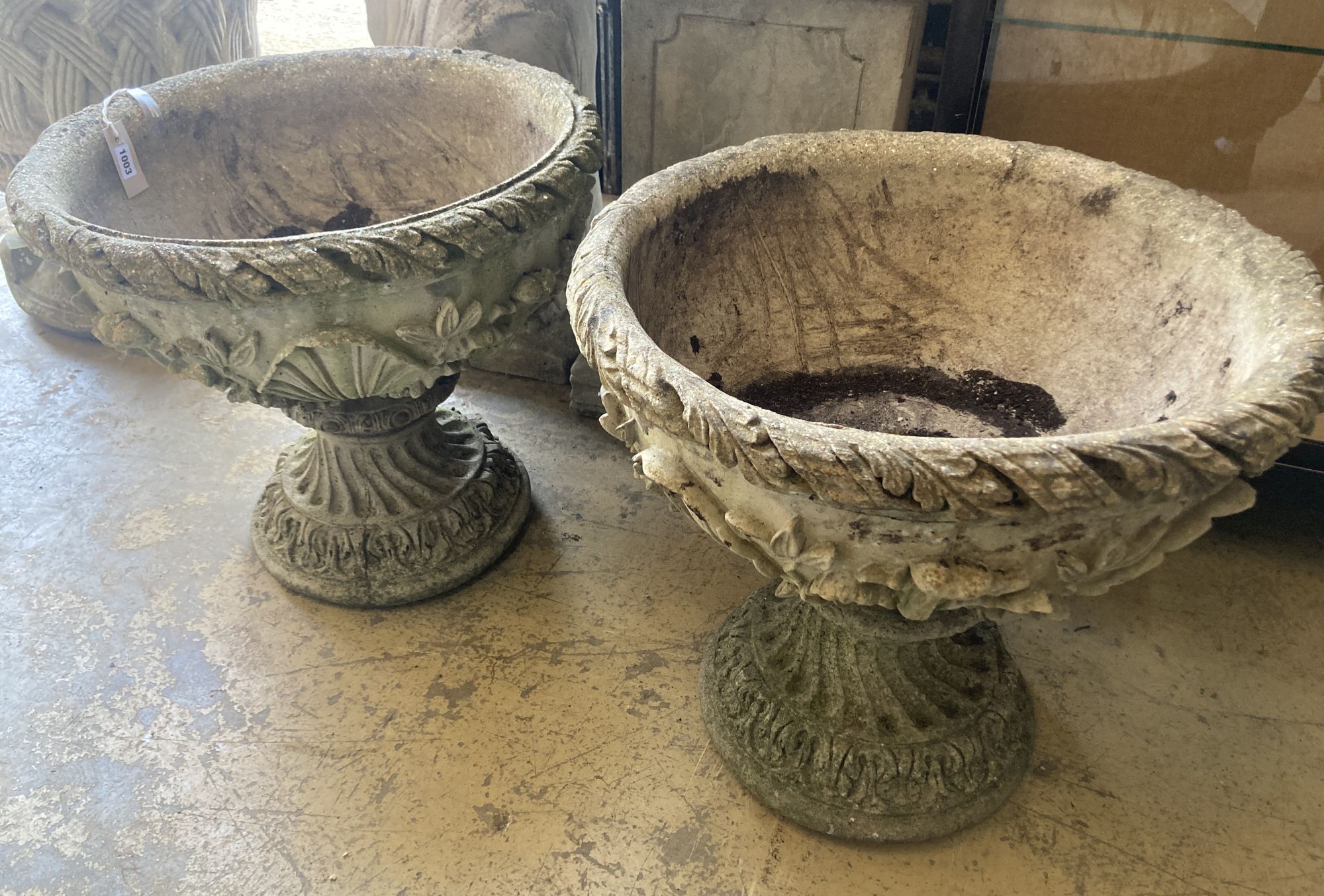 A pair of reconstituted garden stone planters, 54cm diameter, height 51cm